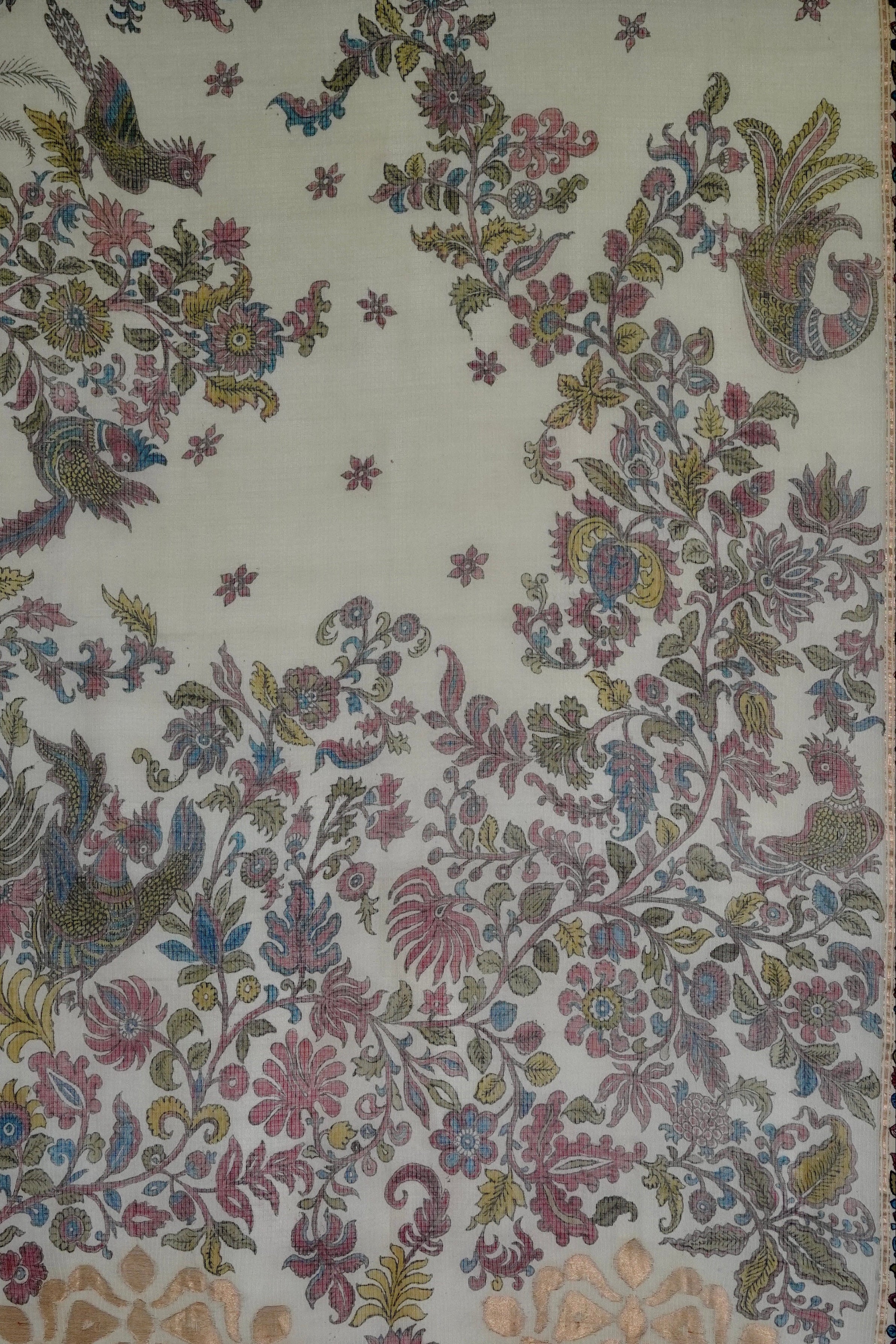 A detailed image of a handwoven sari fabric with a floral and animal pattern, predominantly in shades of blue and green on a light background.